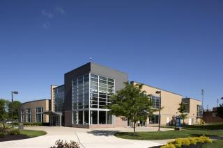 Grey and tan brick and windows of the Talon Center on a sunny day on the Coppin State University campus.