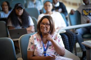 An adult student listens attentively in the classroom