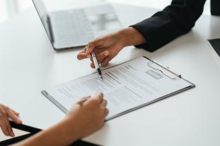 A staff member and student reviewing a resume document